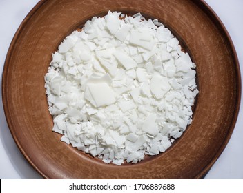 Close Up Of White Soy Wax Flakes For Candle Making On Brown Plate. Light Texture Of Soy Wax Flakes. Ingredient For Homemade Candles. Ecological Lifestyle