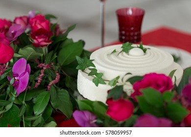 Close up white wedding cake and table decorated with flowers