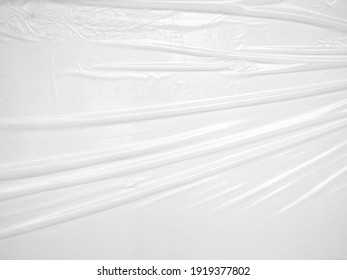 Close Up White Wrinkled Plastic Sheet, Opaque Plastic With Glossy Finish Texture For Use As Background For Poster Advertising