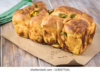 Close Up Of Whole Jalapeno Cheese Bread On A Table.