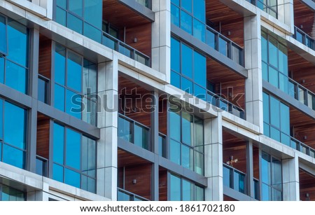 Close up of windows and balconies of a modern multi dwelling building of strata title living scheme.