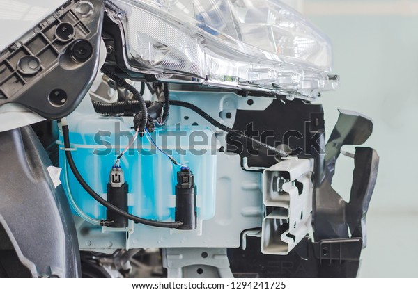 Close up windshield washer and \
water to injection bottle for glass component of car\
engine