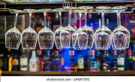 Close Up Wine Glass On Rack Above Counter Bar