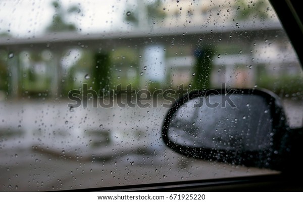 close up\
of wing mirror at the car in the raining\
day.