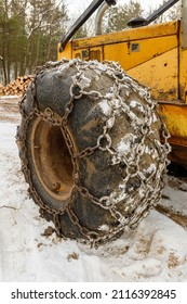 Close up of Winter Chains on Yellow Logging Skidder 