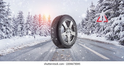 close up winter tires on a snowy road in the mountains - snow storm 