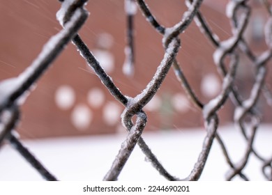Close up of Wire Mesh.Security fence.Private area.Concept of confinement.Steel barrier.Mesh mesh. Lattice barrier. Wire mesh. Security fence with snow. Private area in winter. Snow on fence