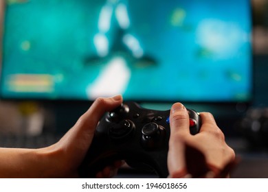 Close up of wireless console, player playing online space shooter game for live competition. Professional pro gamer streaming online video game new graphics using powerful computer