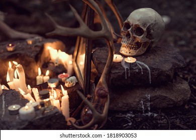 Close Up Of Witch Altar With Burning Candles, Skull And Deer Antlers