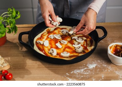 close up of woman adding mushrooms on home made pizza - Shutterstock ID 2223560875