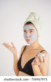 Close Up Of Woman Applying Clay Mask On Her Face And Showing Don't Care React