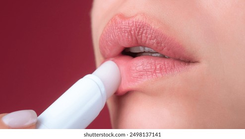 Close up woman applying red lipstick on lips. Sexy girl applied lipstick. Red lips lipstick make up. Putting lipstick on lips.