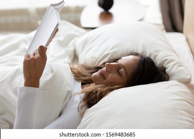 Close Up Of Woman Awakened Lies In Bed Hold Educational Material Learns Information At Test Day, Book Lover Read Next Chapter In Morning, Start New Day With Hobby, Enjoy Weekend And Pastime Concept