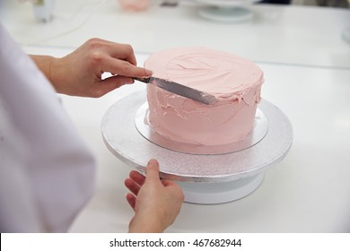 Close Up Of Woman In Bakery Decorating Cake With Icing - Powered by Shutterstock