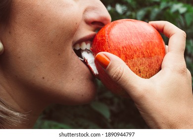 
Close Up Of Woman Biting Red Apple.