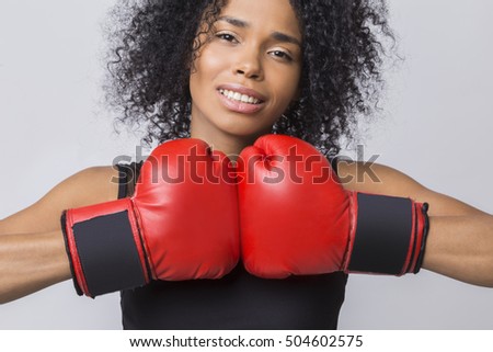 Close up of woman in black tank top with muscles in her arms ready to begin her boxing match. Concept of Olympic games