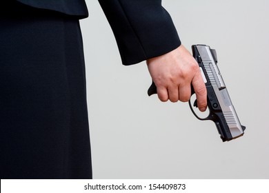 Close Up Of Woman In Business Suit Holding A Gun Back Side