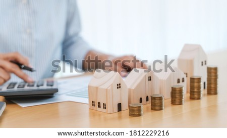 Close up woman calculating property valuation.