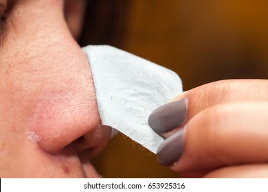 close up of woman with clear-up strips on nose