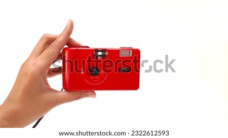 close up of a woman of color's hand  holding a red analog camera. Isolated on white background