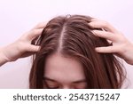 Close up of woman with dirty and greasy hair. Oily hair problem