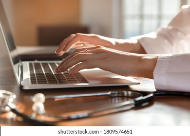 Close Up Woman Doctor Working On Laptop, Typing On Keyboard, Therapist Physician Nurse Sitting At Work Table In Hospital Office, Using Medical Apps, Consulting Online, Writing Report