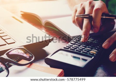 Close up woman doing finance at home office with calculate expenses