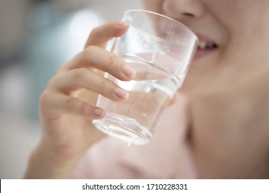 Close up of woman drinking glass of water