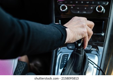 Close Up Of Woman Driver Holding Her Hand On Automatic Gear Shift Stick Driving As Car