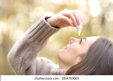 Close Up Of A Woman With Dry Eyes Applying Artificial Tear In Winter In A Park