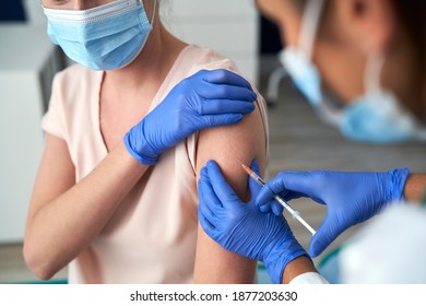 Close up of woman during vaccination in a doctor's office                                - Shutterstock ID 1877203630