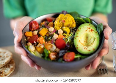 Close Up Of Woman Eating Healthy Vegan Meal In Bowl