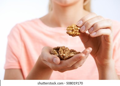 Close Up Of Woman Eating Walnuts