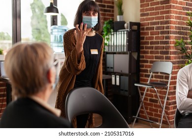 Close Up Of Woman Expressing Anger Management Issues At Aa Group Meeting, Wearing Face Mask. People Attending Therapy Session For Support And Guidance Against Addiction And Depression.