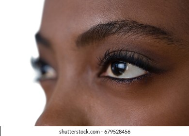 Close Up Of Woman Eyes Looking Away Against White Background