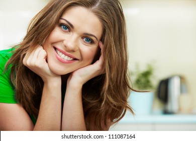 Close Up Woman Face Against Home Kitchen Background. Clothes Of Green Color. Portrait Of Smiling Female Model.