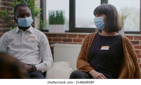 Close Up Of Woman With Face Mask Attending Aa Group Therapy Session. Person Talking To People With Alcohol Addiction, Asking For Guidance And Support During Coronavirus Pandemic.