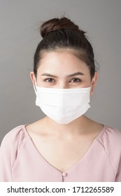 close up woman face is wearing surgical mask  - Shutterstock ID 1712265589
