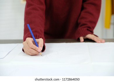 Close up of woman fashion designer hand drawing her design collection on paper in studio, small business owner, fashion industry concept  - Shutterstock ID 1172864050