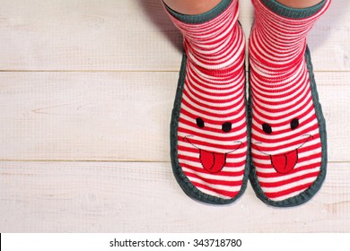 Close Up Of Woman Feet Wearing Funny Socks With With Happy Smiley Face. New Year And Christmas Time, Always Be And Stay Positive Concept 