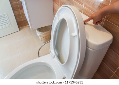 Close Up Woman Flush The Toilet Bowl For Hygiene