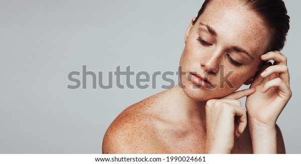 Close up of woman with freckles on\
body. Portrait of woman showing her beautiful\
freckles.