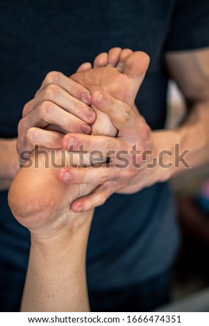 Close up of woman getting a physical therapy foot massage.