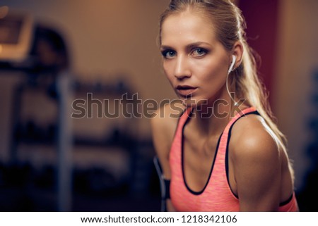 Close up of woman in gym. Looking at camera, sportswear.