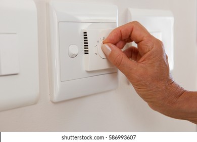 Close Up Woman Hand Adjusting Temperature On Dial