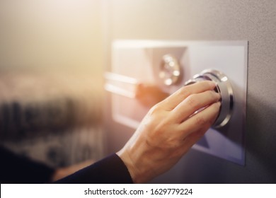 Close up of a woman hand hold and tuning on a combinations safe dial lock - Shutterstock ID 1629779224
