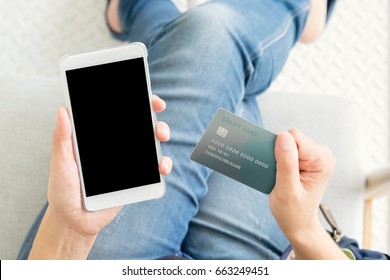 Close Up Woman Hand Holding Credit Card And Blank Screen Mobile Phone Sitting At Coffee Shop,online Shopping Concept,mock Up For Display Or Montage Of Product Or Design