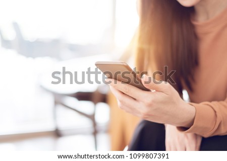 Close up woman hand holding mobile phone, She using in mobile applications and multimedia programs. copy space