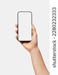 Close up of woman hand holding modern smart phone mockup. New modern black frameless smartphone mockup with blank white screen. Isolated on white background high quality studio shot Modern smart