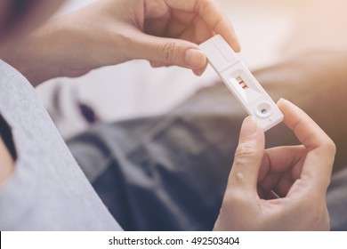 Close Up Of Woman Hand Holding A Positive Home Pregnancy Test.